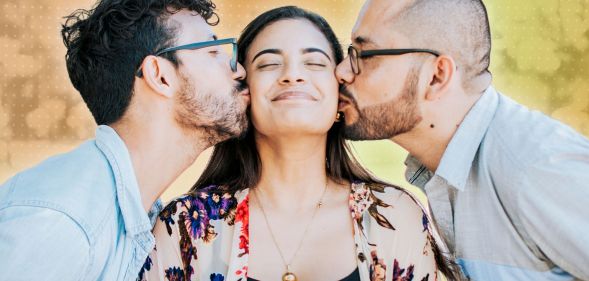 Two people kissing one person.