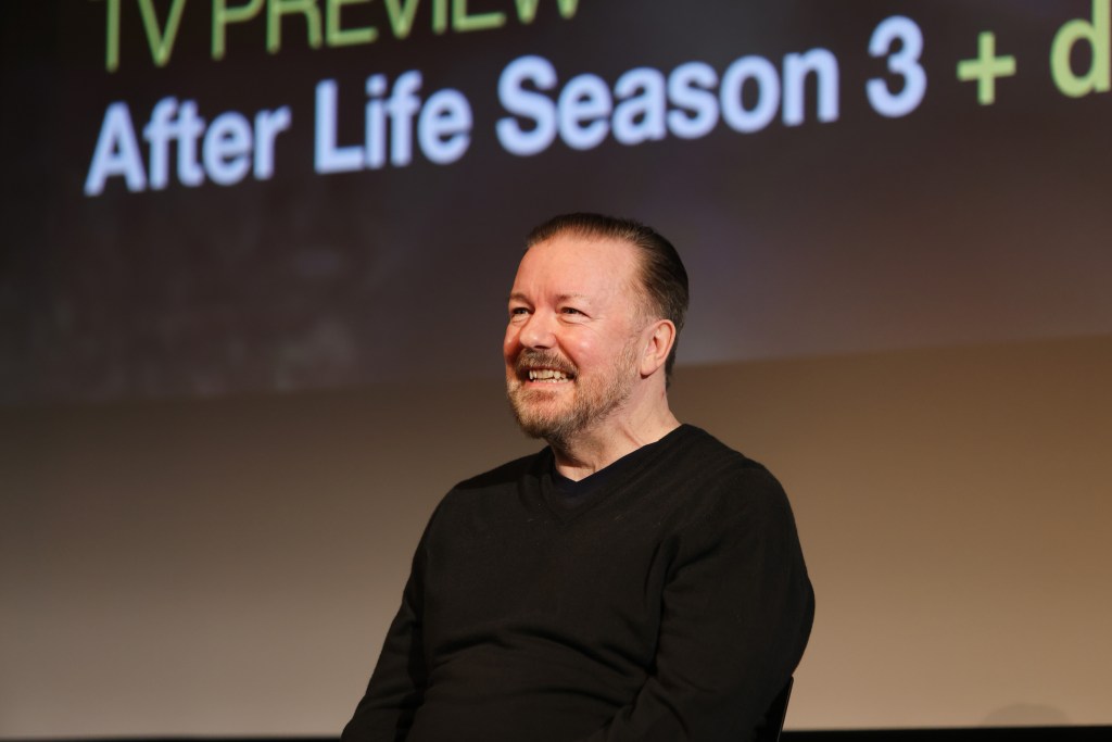 Ricky Gervais onstage smiling