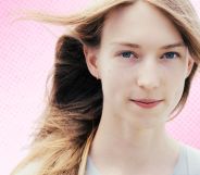 A trans woman superimposed on a pink gradient background.