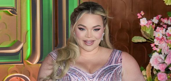 Trisha Paytas smiles while wearing a pink gown on the Wicked red carpet.