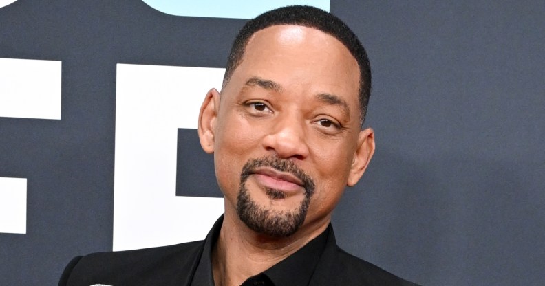 Will Smith at the 67th GRAMMY Awards. Wearing a black suit against a grey backgrop