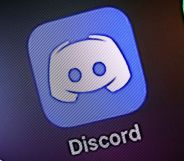 A phone with the Discord app displayed.
