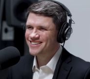 James Talarico, pictured in a recording booth with headphones on.