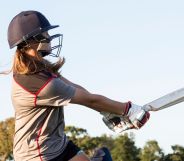 Someone swinging a cricket bat.