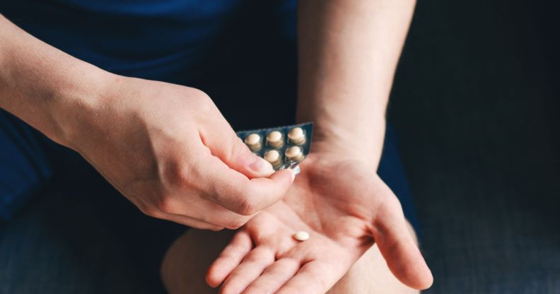 A person using a packet of hormones.