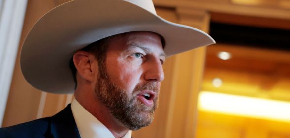 Markwayne Mullin, a white man with a beard, wearing a cowboy hat