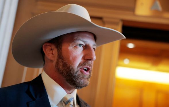 Markwayne Mullin, a white man with a beard, wearing a cowboy hat