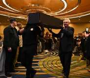 Pallbearers proceed with symbolic coffins at the Save HIV Funding Campaign's Funeral Protest and Celebration of Life.