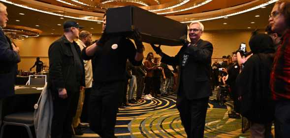 Pallbearers proceed with symbolic coffins at the Save HIV Funding Campaign's Funeral Protest and Celebration of Life.