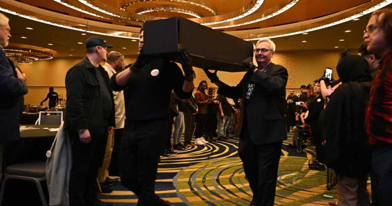 Pallbearers proceed with symbolic coffins at the Save HIV Funding Campaign's Funeral Protest and Celebration of Life.