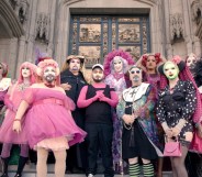 Hunky Jesus still: a group of people outside a religious building dressed in drag as nuns.