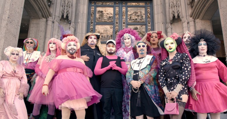 Hunky Jesus still: a group of people outside a religious building dressed in drag as nuns.