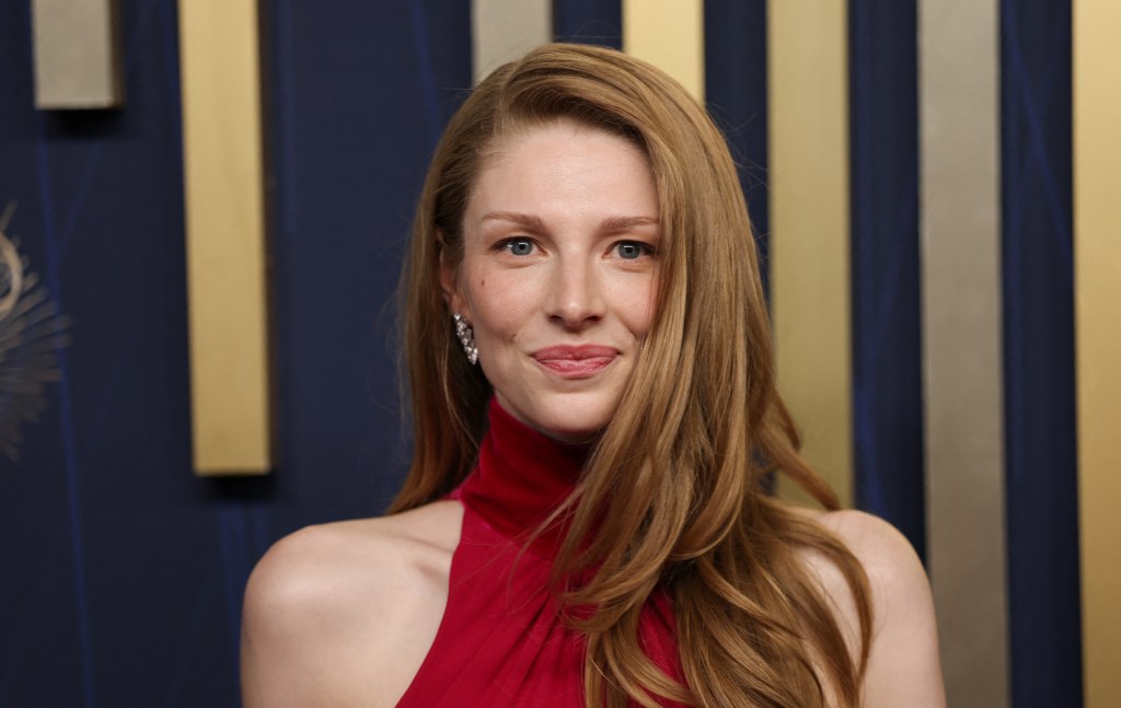 Hunter Schafer with her blonde hair down in a high neck red dress