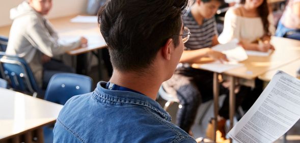 The back of a teacher at a school.