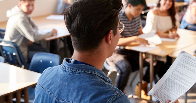 The back of a teacher at a school.