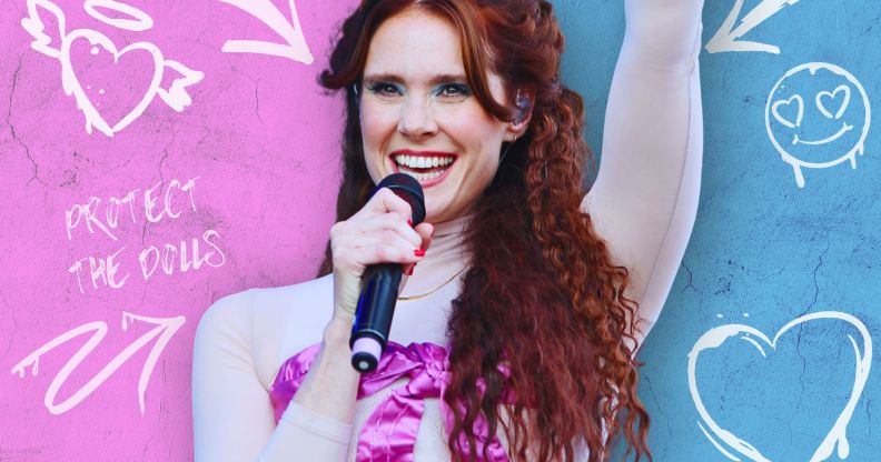 Kate Nash in front of an edited wall with graffiti across it.