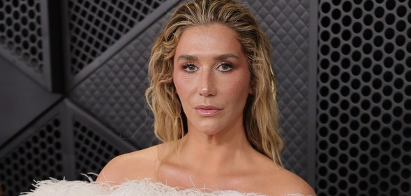 Kesha attends the 68th GRAMMY Awards, wearing a strapless feathered white dress.