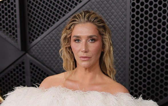 Kesha attends the 68th GRAMMY Awards, wearing a strapless feathered white dress.