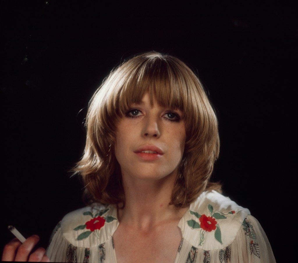 Singer Marianne Faithfull poses in a floral dress