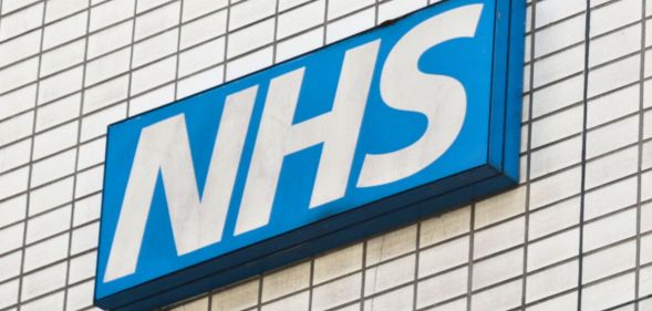 A skewed shot of an NHS sign.