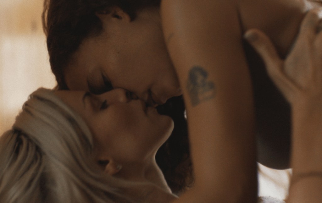 Perfect still: Ashley Moore on top of Julia Fox, kissing her