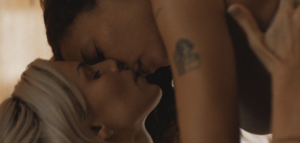 Perfect still: Ashley Moore on top of Julia Fox, kissing her