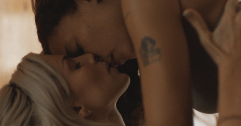 Perfect still: Ashley Moore on top of Julia Fox, kissing her