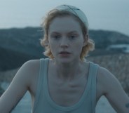 Satisfaction's Emma Laird as Lola, cycling in a vest top by the beach