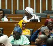 Majority deputies celebrate after the adoption of a law doubling the penalties for homosexuality at the National Assembly in Dakar.