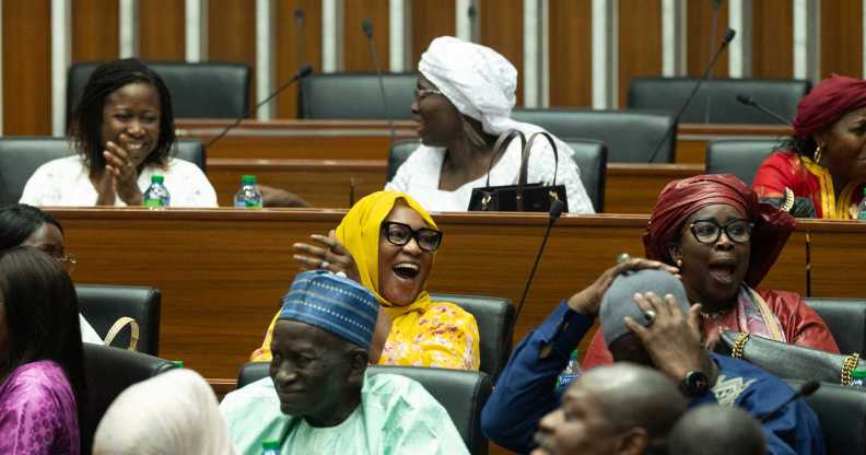Majority deputies celebrate after the adoption of a law doubling the penalties for homosexuality at the National Assembly in Dakar.