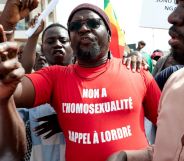 A Senegalese man wearing a Occitan shirt reading "no to homosexuality, recall order to Senegal".