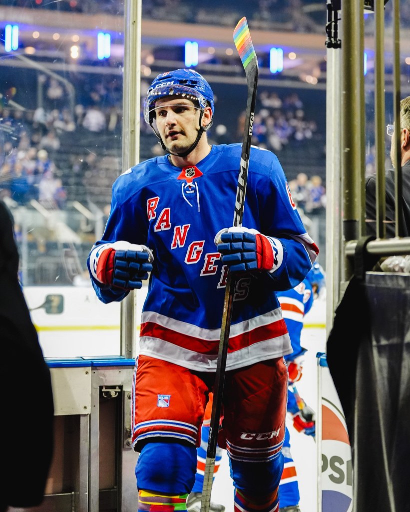 New York Rangers player Vincent Iorio with rainbow tape on his stick