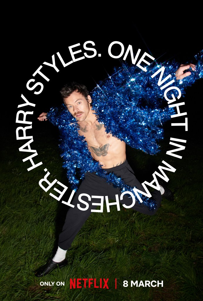 Netflix ad for Harry Styles One Night in Manchester. White 'Harry Styles One Night in Manchester' text in a cirle around Styles in a bright glittery blue jacket throwing his hands back in a pose.