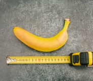 banana on a grey table with a measuring tape below it