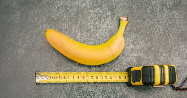banana on a grey table with a measuring tape below it