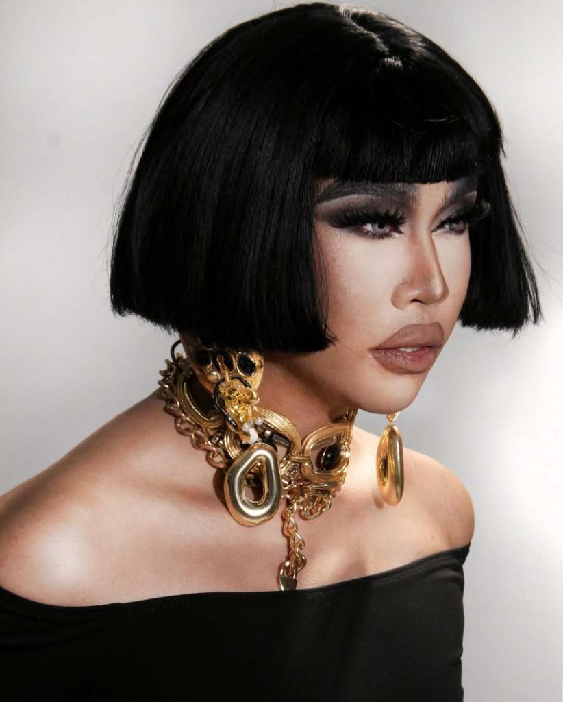 Drag Race: Philippines star Misua in a black dress and chunky gold jewellery