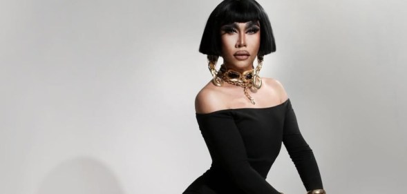 Drag Race: Philippines star Misua in a black dress and chunky gold jewellery
