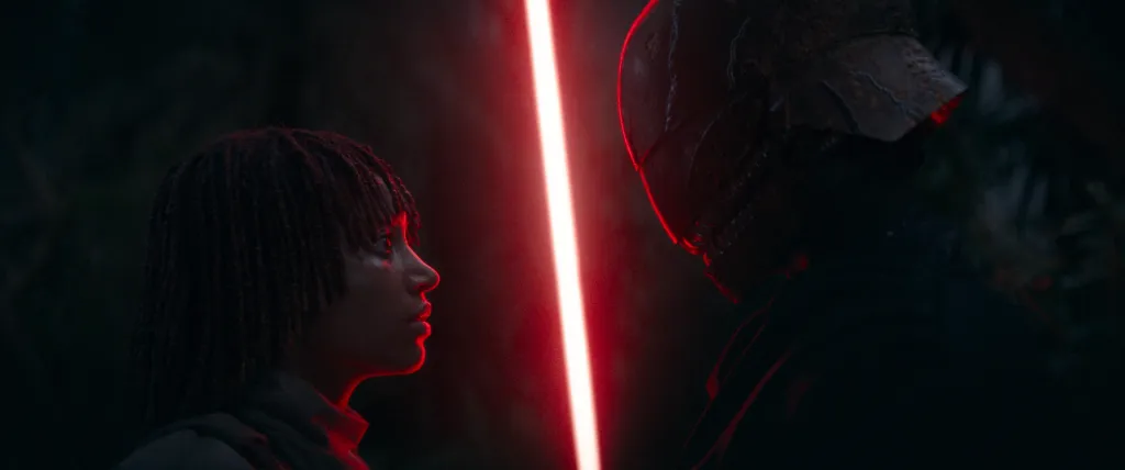Star Wars' The Acolyte still: a red light saber between Osha and a masked figure.
