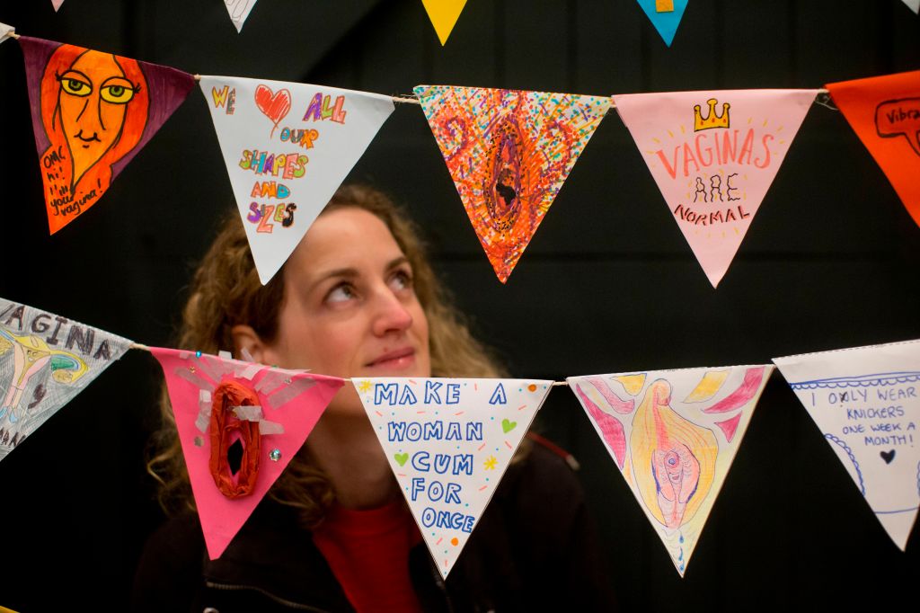 A visitor looks at a line of vagina themed bunting during the press preview of the new Vagina Museum