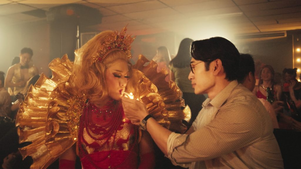 A Good Child still: a drag queen lighting her cigarette from a man in a shirt