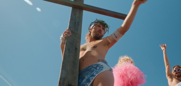 The Sisters of Perpetual Indulgens host the Hunky Jesus competition. A nab ib stage dresses as jesus with a big wooden cross