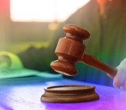 judge's hammer over pride flag colours