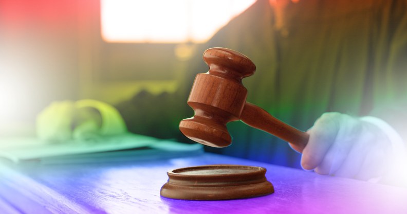 judge's hammer over pride flag colours