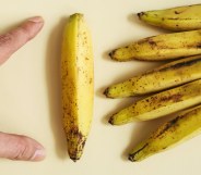 man measuring a banana