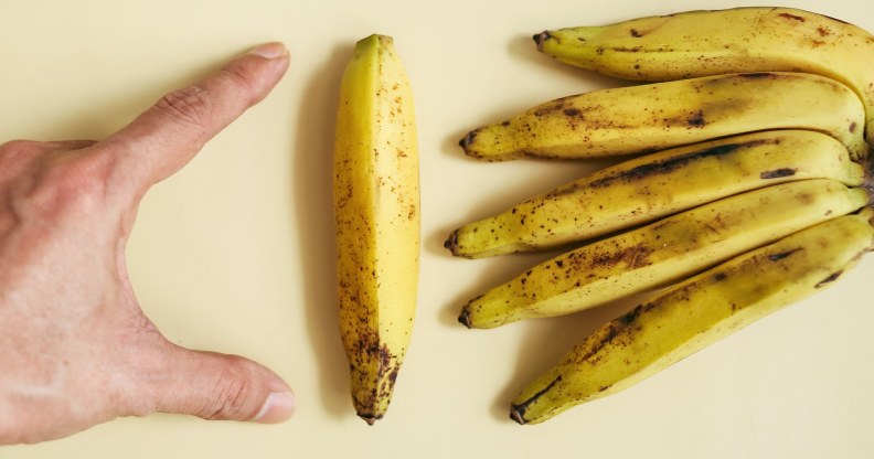 man measuring a banana