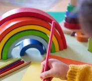 Preschooler with a rainbow toy