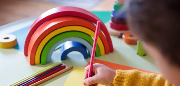 Preschooler with a rainbow toy