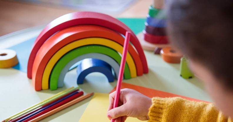 Preschooler with a rainbow toy