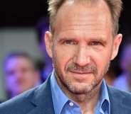 Headshot of Ralph Fiennes wearing a blue shirt and blazer