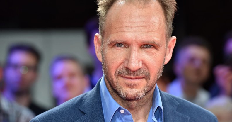 Headshot of Ralph Fiennes wearing a blue shirt and blazer